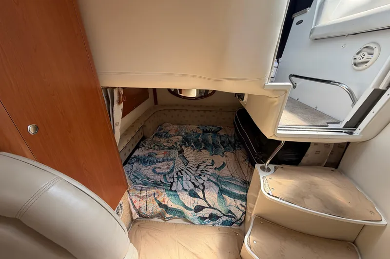 Slide: The Image of Interior cabin of 2003 Four Winns 328 Vista boat with cozy bedding and wooden accents. - 22