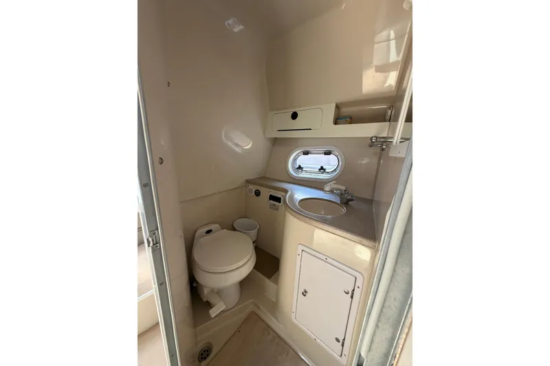 Slide: The Image of 2003 Four Winns 328 Vista boat bathroom with toilet, sink, and storage. - 24