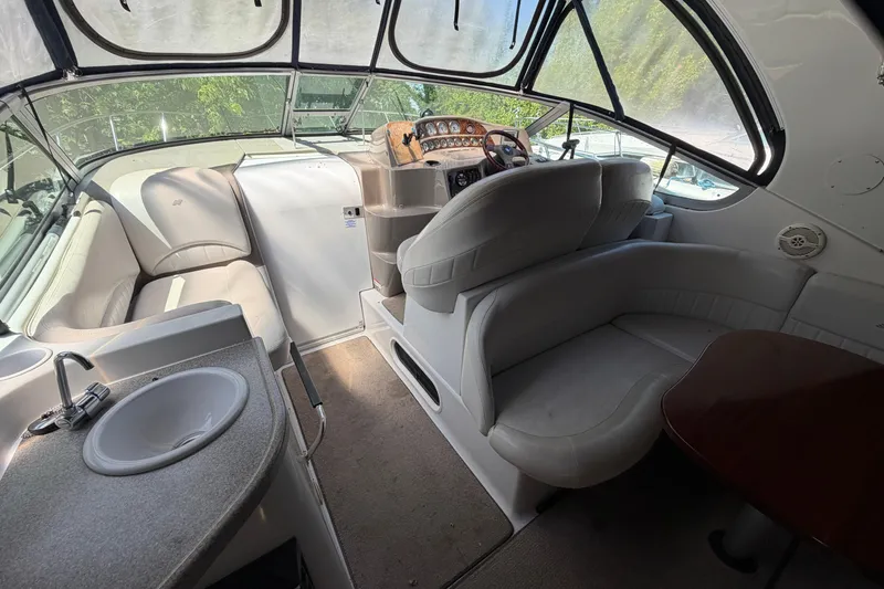 Slide: The Image of Interior of 2003 Four Winns 328 Vista boat with seating, sink, and helm. - 3