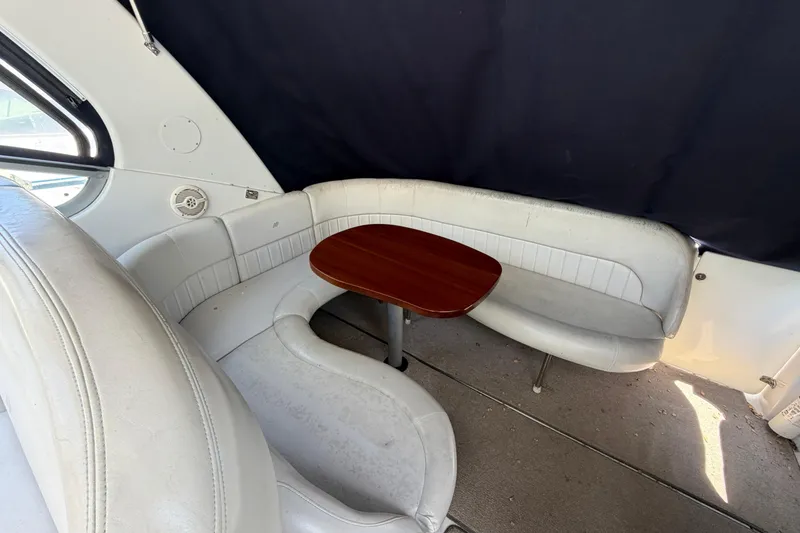 Slide: The Image of 2003 Four Winns 328 Vista boat interior with white seating and wooden table. - 4