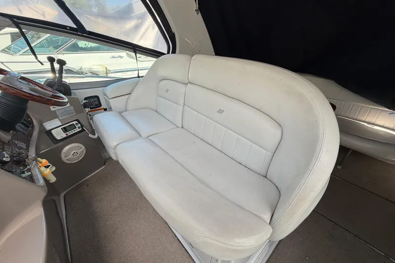 Slide: The Image of 2003 Four Winns 328 Vista boat interior with white leather seating and control panel. - 5