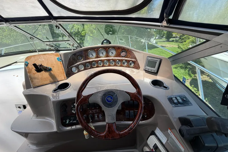 Slide: The Image of 2003 Four Winns 328 Vista boat dashboard with steering wheel and gauges. - 7