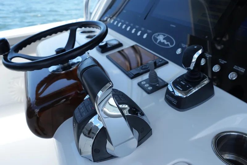 Slide: The Image of Control panel of 2022 Valhalla Boatworks V-41 with steering wheel and throttle controls. - 10