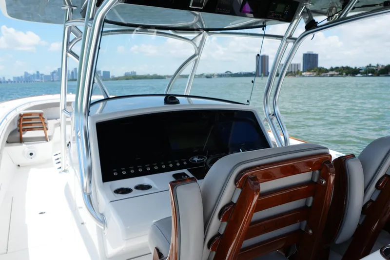 Slide: The Image of 2022 Valhalla Boatworks V-41 helm with modern controls, overlooking scenic waterfront. - 18