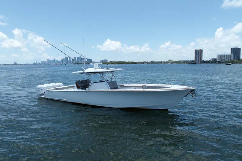 Slide: The Image of 2022 Valhalla Boatworks V-41 on calm water with city skyline in background. - 2