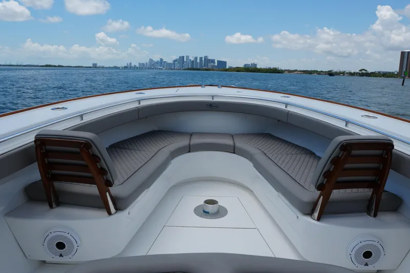 Slide: The Image of 2022 Valhalla Boatworks V-41 with spacious seating, ocean view, and city skyline in the background. - 20