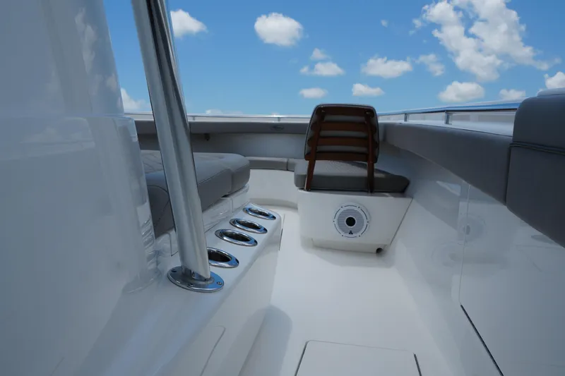 Slide: The Image of 2022 Valhalla Boatworks V-41 interior with seating and rod holders under a blue sky. - 27