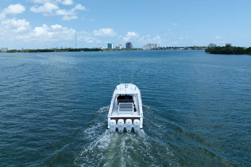 Slide: The Image of 2022 Valhalla Boatworks V-41 cruising on a serene blue waterway under a clear sky. - 7