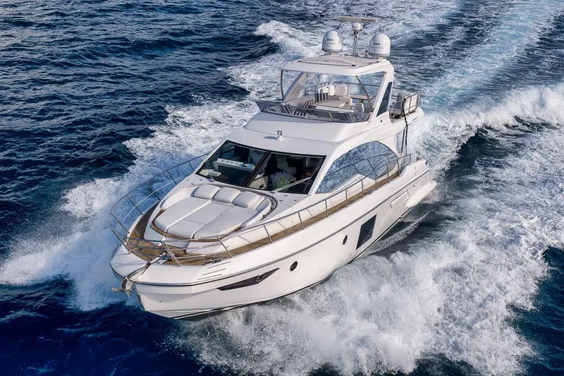 Slide: The Image of Luxurious 2019 Azimut 55 yacht cruising on open sea, creating dynamic waves. - 10
