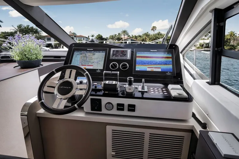 Slide: The Image of Cockpit of 2019 Azimut 55 yacht with modern navigation displays and steering wheel. - 105