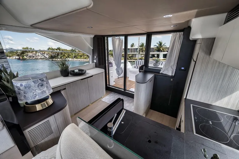 Slide: The Image of Luxurious interior of a 2019 Azimut 55 yacht with modern kitchen and scenic water view. - 106