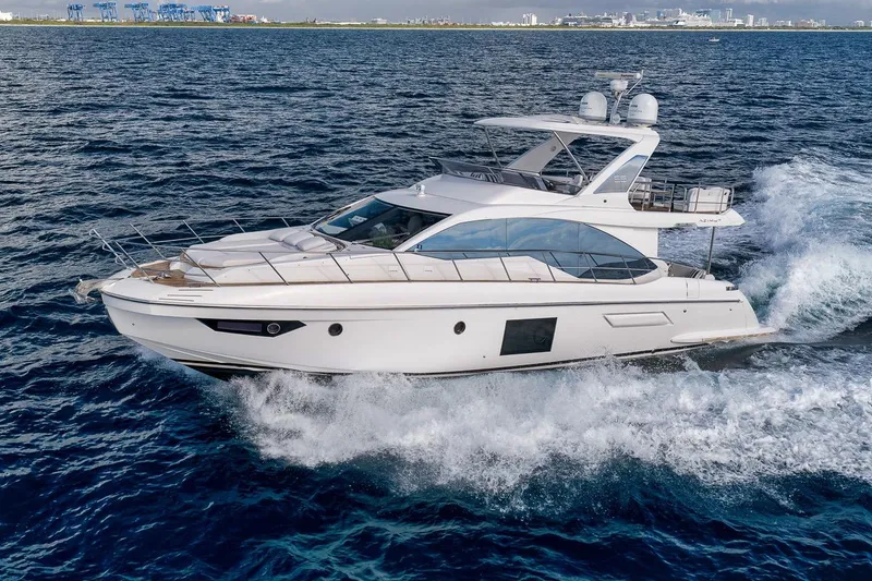 Slide: The Image of 2019 Azimut 55 yacht cruising on open water, showcasing sleek design and luxury. - 11