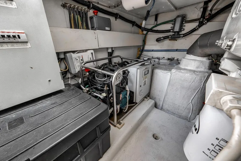 Slide: The Image of Engine room of a 2019 Azimut 55 yacht, showcasing mechanical components and wiring. - 113