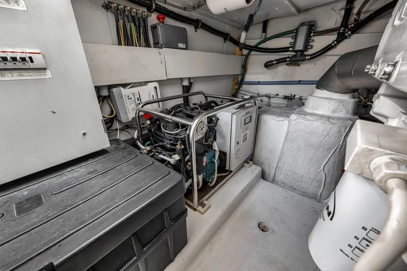 Slide: The Image of Engine room of a 2019 Azimut 55 yacht, showcasing mechanical components and wiring. - 114