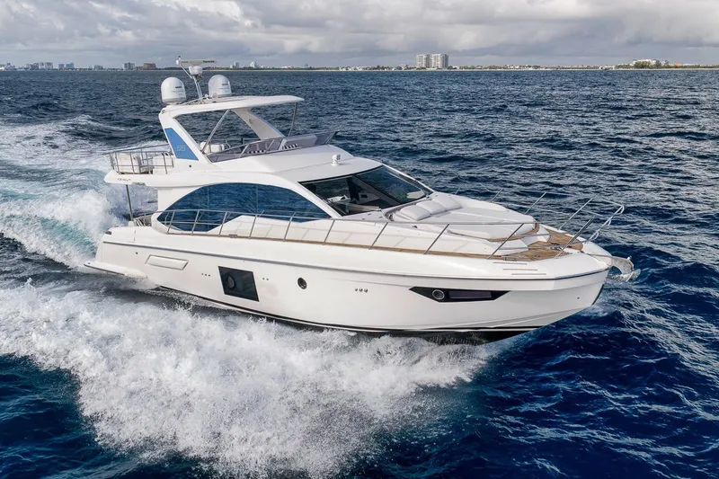 Slide: The Image of 2019 Azimut 55 yacht cruising on open ocean waters. - 12