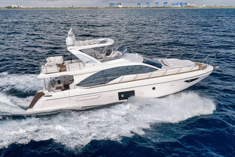 Slide: The Image of Luxurious 2019 Azimut 55 yacht cruising on open sea, showcasing sleek design and elegance. - 13