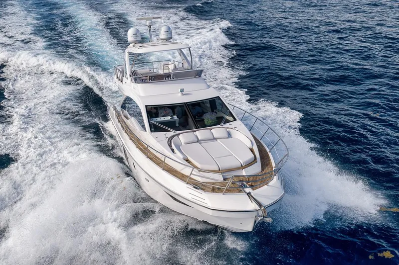 Slide: The Image of Luxurious 2019 Azimut 55 yacht cruising through ocean waves, showcasing sleek design and elegance. - 16