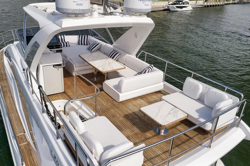Slide: The Image of Luxurious 2019 Azimut 55 yacht with spacious deck, elegant seating, and modern amenities. - 18