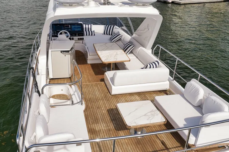 Slide: The Image of Luxurious 2019 Azimut 55 yacht deck with elegant seating and tables on the water. - 19