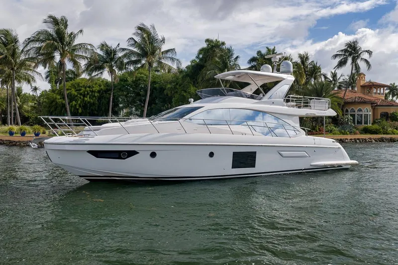 Slide: The Image of Luxurious 2019 Azimut 55 yacht cruising near tropical shoreline with palm trees. - 23