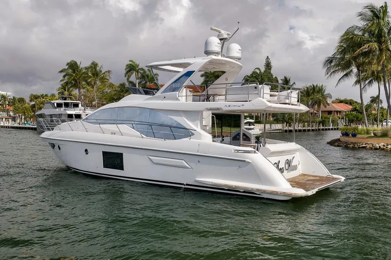 Slide: The Image of 2019 Azimut 55 yacht cruising on a tropical waterway with palm trees. - 25