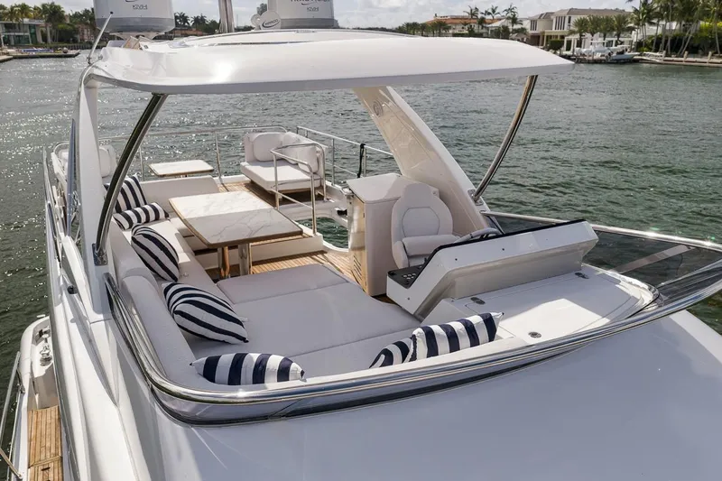 Slide: The Image of Luxurious 2019 Azimut 55 yacht with elegant seating and striped cushions on deck. - 35
