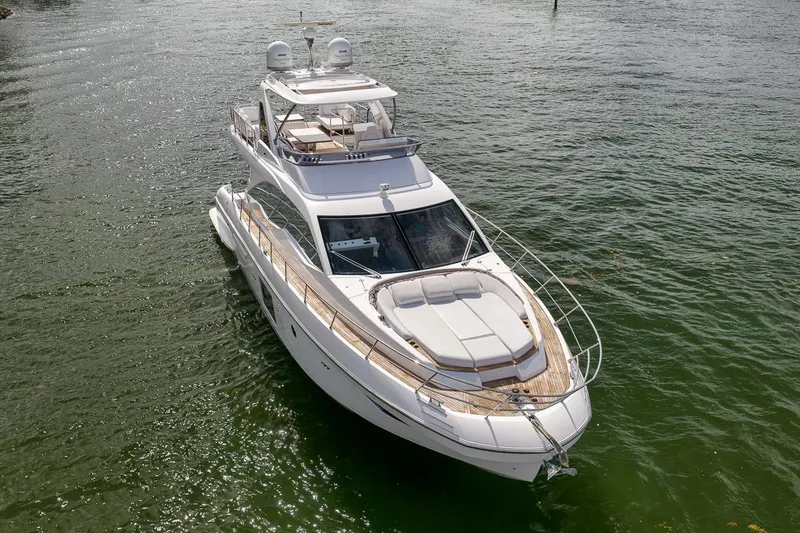 Slide: The Image of Luxurious 2019 Azimut 55 yacht cruising on calm waters, showcasing sleek design and spacious deck. - 36