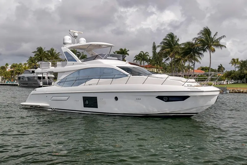 Slide: The Image of 2019 Azimut 55 yacht cruising on a tropical waterway with palm trees. - 39