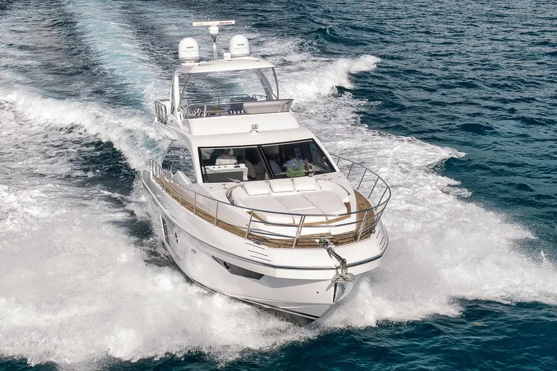Slide: The Image of 2019 Azimut 55 yacht cruising on open sea, showcasing luxury and performance. - 4