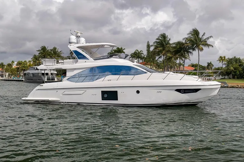 Slide: The Image of 2019 Azimut 55 yacht cruising on a tropical waterway with palm trees. - 40