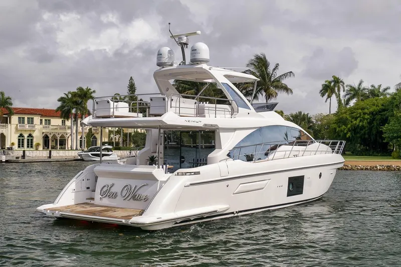 Slide: The Image of 2019 Azimut 55 yacht cruising near waterfront homes and palm trees. - 43