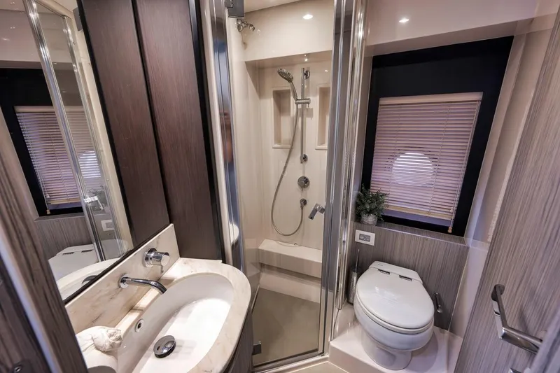 Slide: The Image of Luxurious bathroom in a 2019 Azimut 55 yacht, featuring modern fixtures and elegant design. - 56