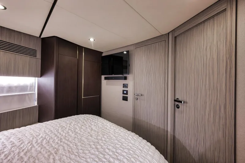 Slide: The Image of Luxurious bedroom interior of 2019 Azimut 55 yacht with modern design and cozy bedding. - 57