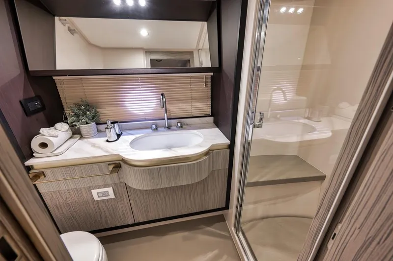 Slide: The Image of Luxurious bathroom in a 2019 Azimut 55 yacht, featuring modern fixtures and elegant design. - 62