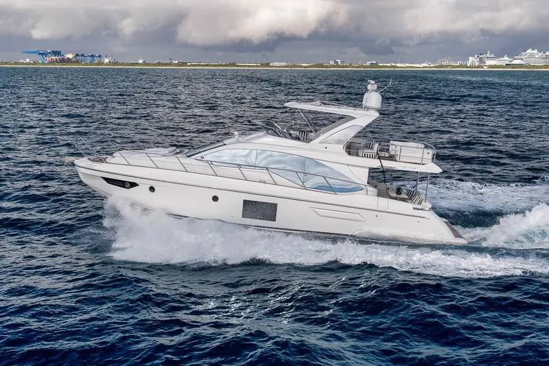 Slide: The Image of 2019 Azimut 55 yacht cruising on open water under cloudy skies. - 7