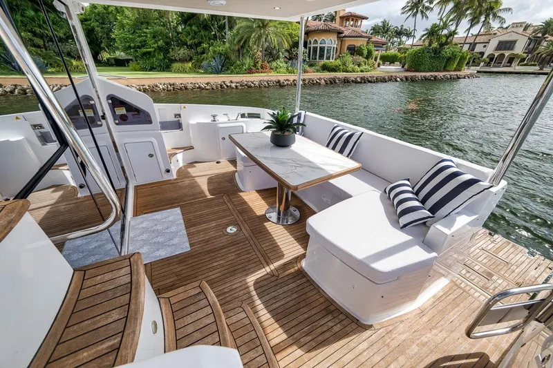 Slide: The Image of Luxurious 2019 Azimut 55 yacht deck with elegant seating and scenic waterfront view. - 74