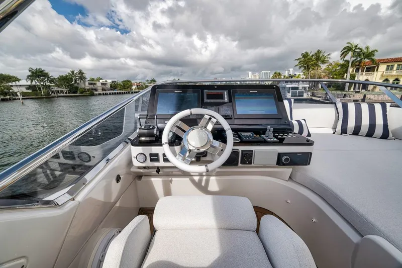 Slide: The Image of Cockpit view of 2019 Azimut 55 yacht with modern navigation equipment and luxurious seating. - 79