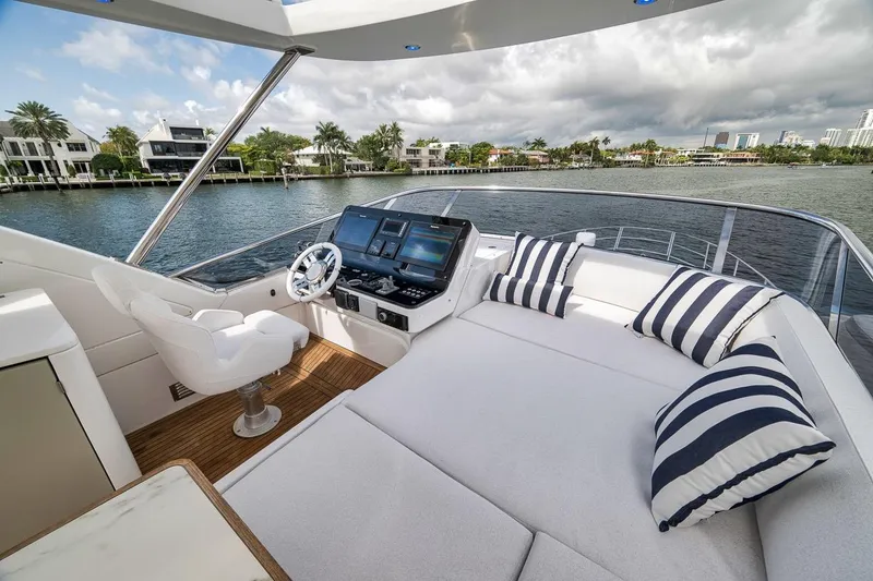 Slide: The Image of Luxurious 2019 Azimut 55 yacht deck with plush seating and scenic waterfront view. - 82