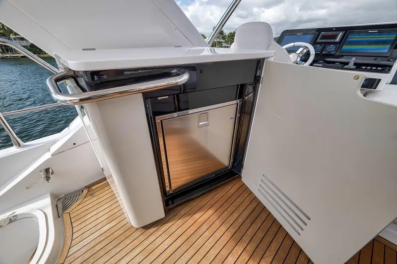 Slide: The Image of 2019 Azimut 55 yacht cockpit with sleek cabinetry and modern navigation equipment. - 84