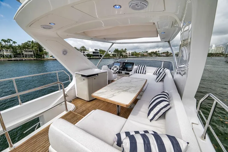 Slide: The Image of Luxurious 2019 Azimut 55 yacht deck with elegant seating and scenic waterfront view. - 89