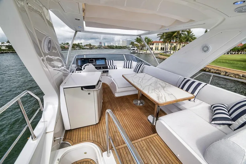 Slide: The Image of Luxurious 2019 Azimut 55 yacht interior with elegant seating and scenic waterfront view. - 90