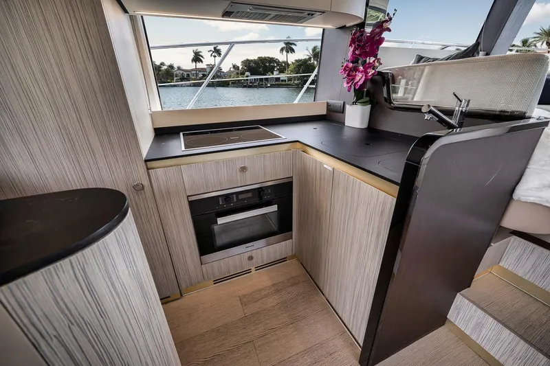 Slide: The Image of Luxurious kitchen interior of 2019 Azimut 55 yacht with modern appliances and scenic window view. - 96