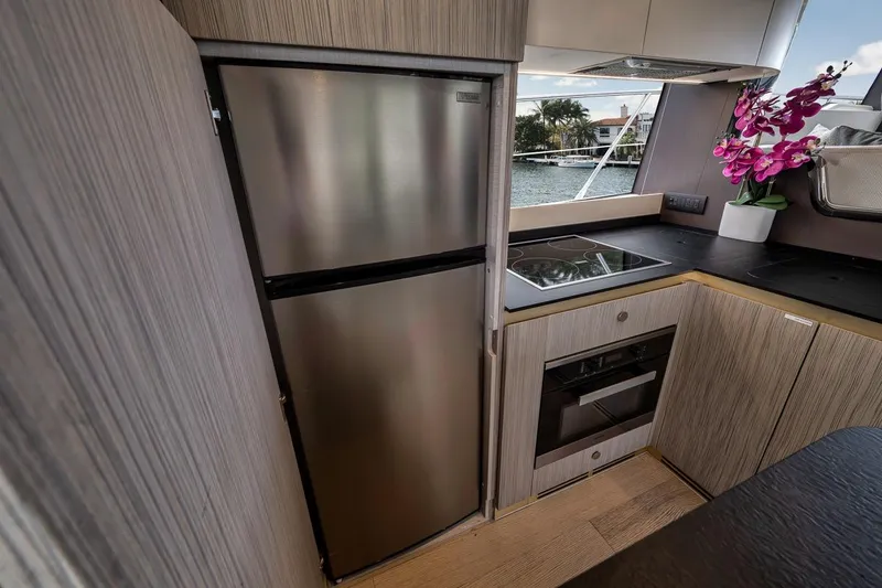 Slide: The Image of Modern kitchen interior of 2019 Azimut 55 yacht with stainless steel appliances and floral decor. - 98