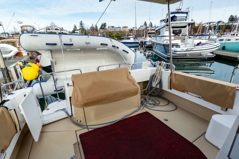 Slide: The Image of 2019 Ranger Tugs R-31-S boat interior with docked inflatable dinghy and marina view. - 8