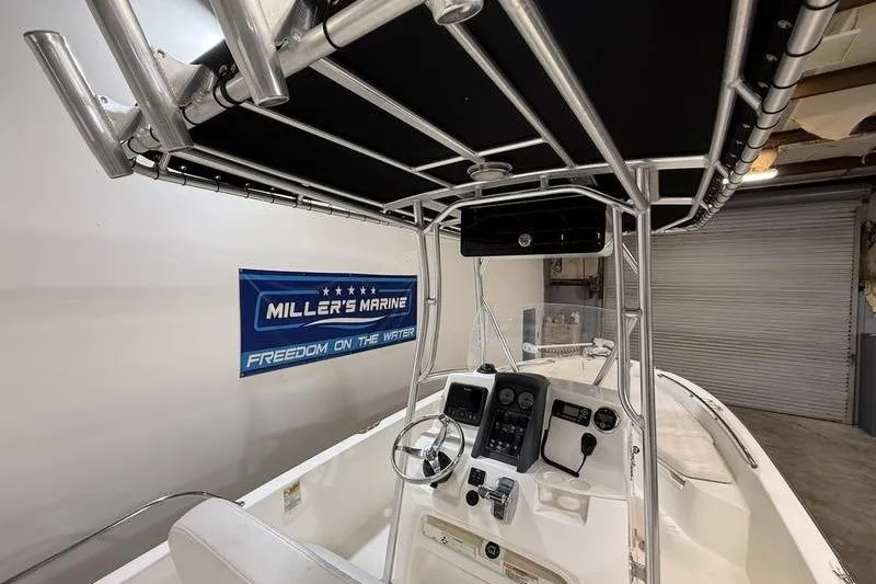 Slide: The Image of 2011 Boston Whaler 230 Dauntless boat interior with steering console and T-top. - 11
