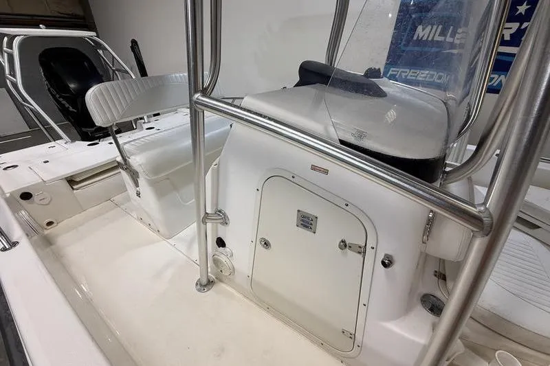 Slide: The Image of 2011 Boston Whaler 230 Dauntless boat interior with seating and console details. - 12
