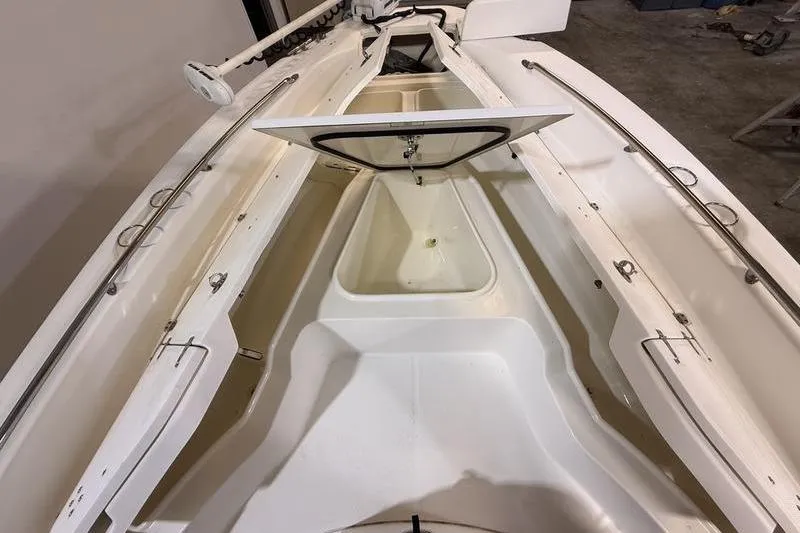 Slide: The Image of 2011 Boston Whaler 230 Dauntless boat interior with open storage compartment. - 16