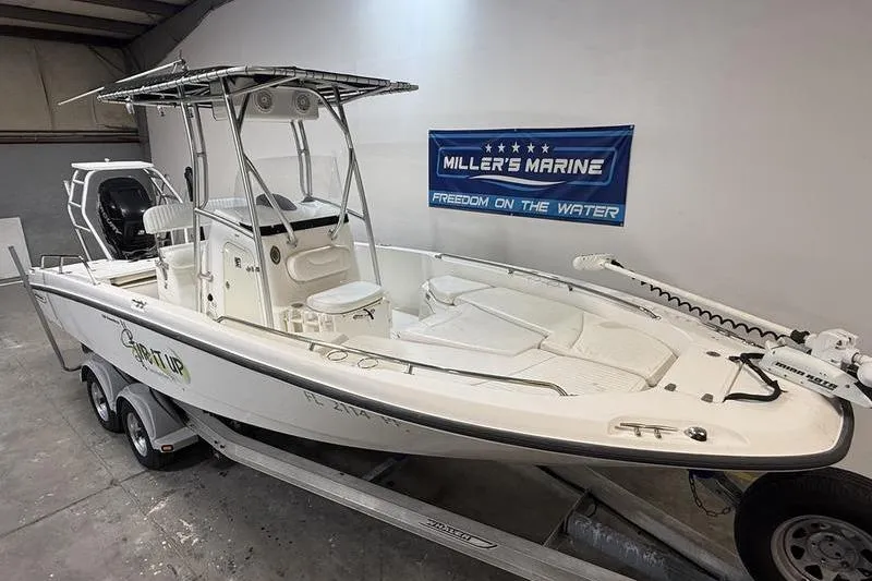 Slide: The Image of 2011 Boston Whaler 230 Dauntless boat on trailer in showroom. - 2