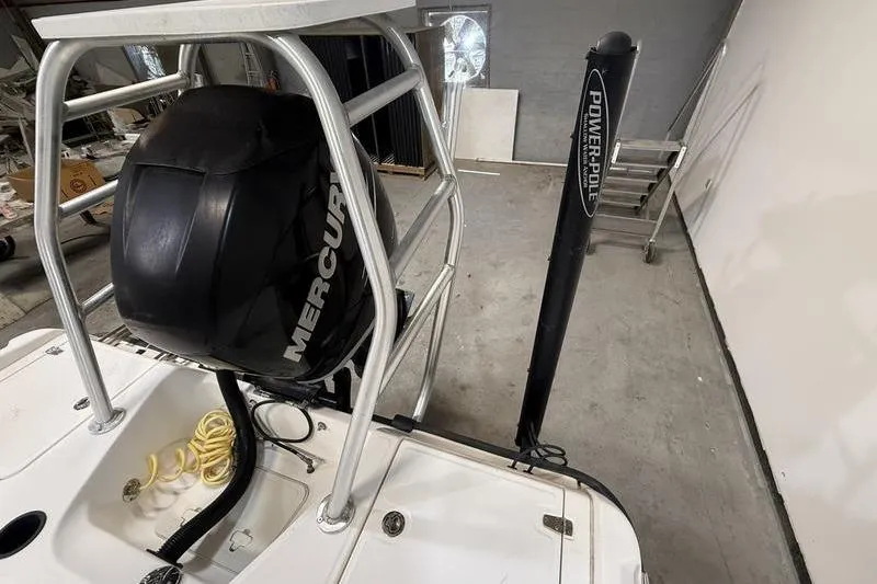 Slide: The Image of 2011 Boston Whaler 230 Dauntless with Mercury engine and Power-Pole in a garage. - 4