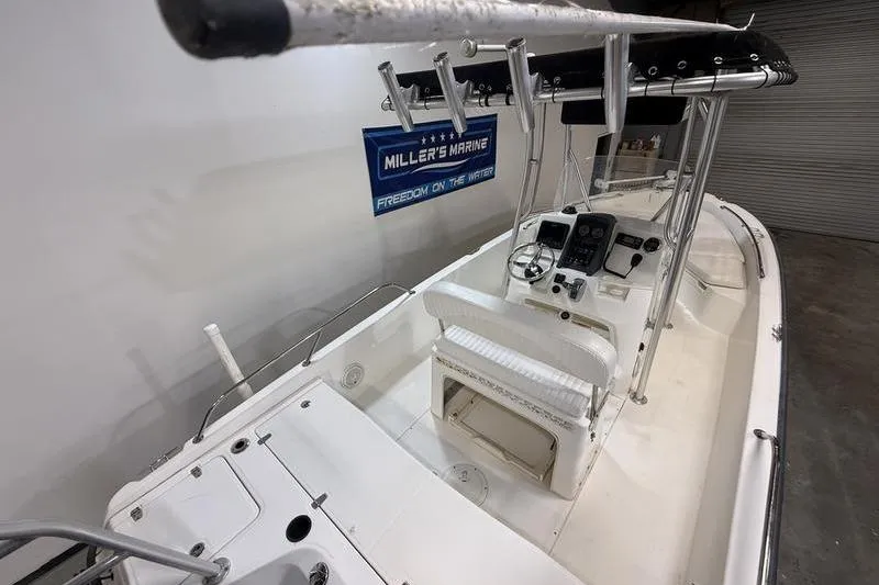 Slide: The Image of 2011 Boston Whaler 230 Dauntless boat interior with steering console and seating. - 5